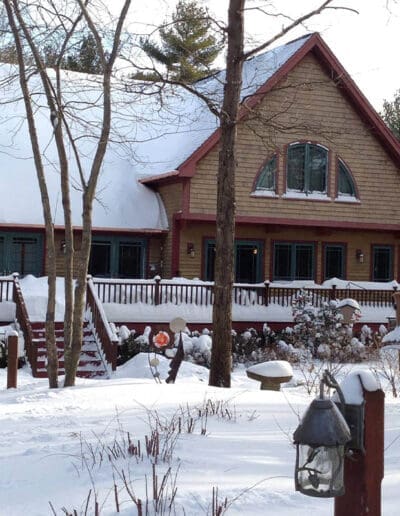 Exterior view of Craftsman home blanketed in snow