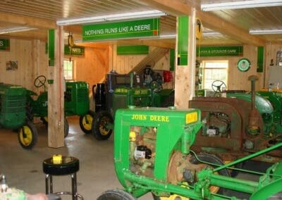 Interior of Tractor Barn filled with vintage John Deere tractors and signage