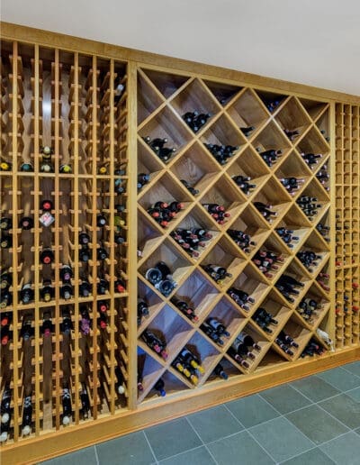 Built-in wine racks holding many bottles of wine.