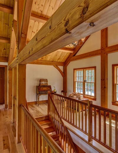 Timber frame loft area at top of stairway