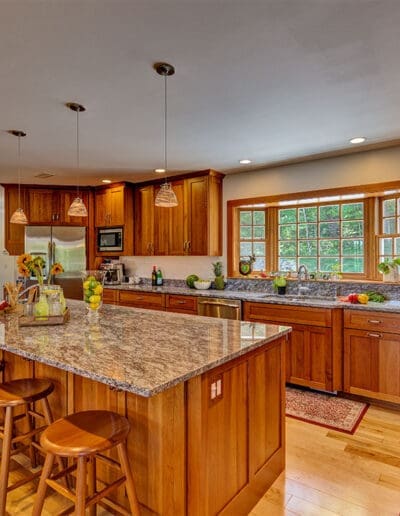 Large kitchen with wooden cabinets, kitchen island and stools