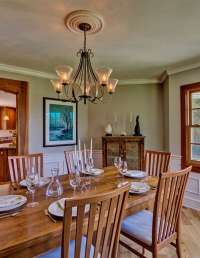 View across dining room table towards the kitchen