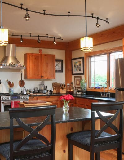 Kitchen with long island with bar seating, stainless steel appliances wooden cabinets