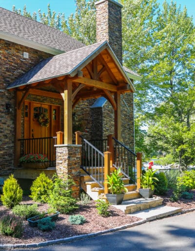 Craftsman's Cottage exterior view of the front with stone facade and red accents