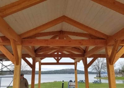 Timber frame ceiling of Meredith Pavilion looking out onto lake