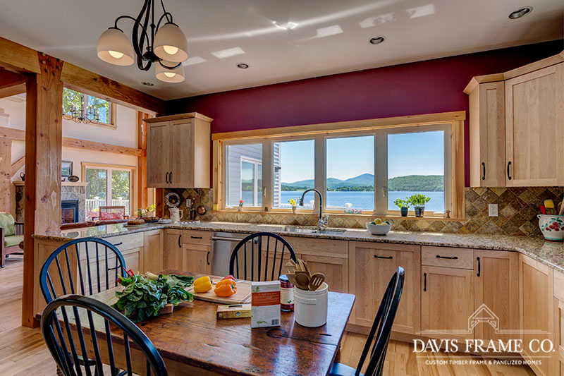 hybrid timber frame home with conventional kitchen and natural wood cabinets